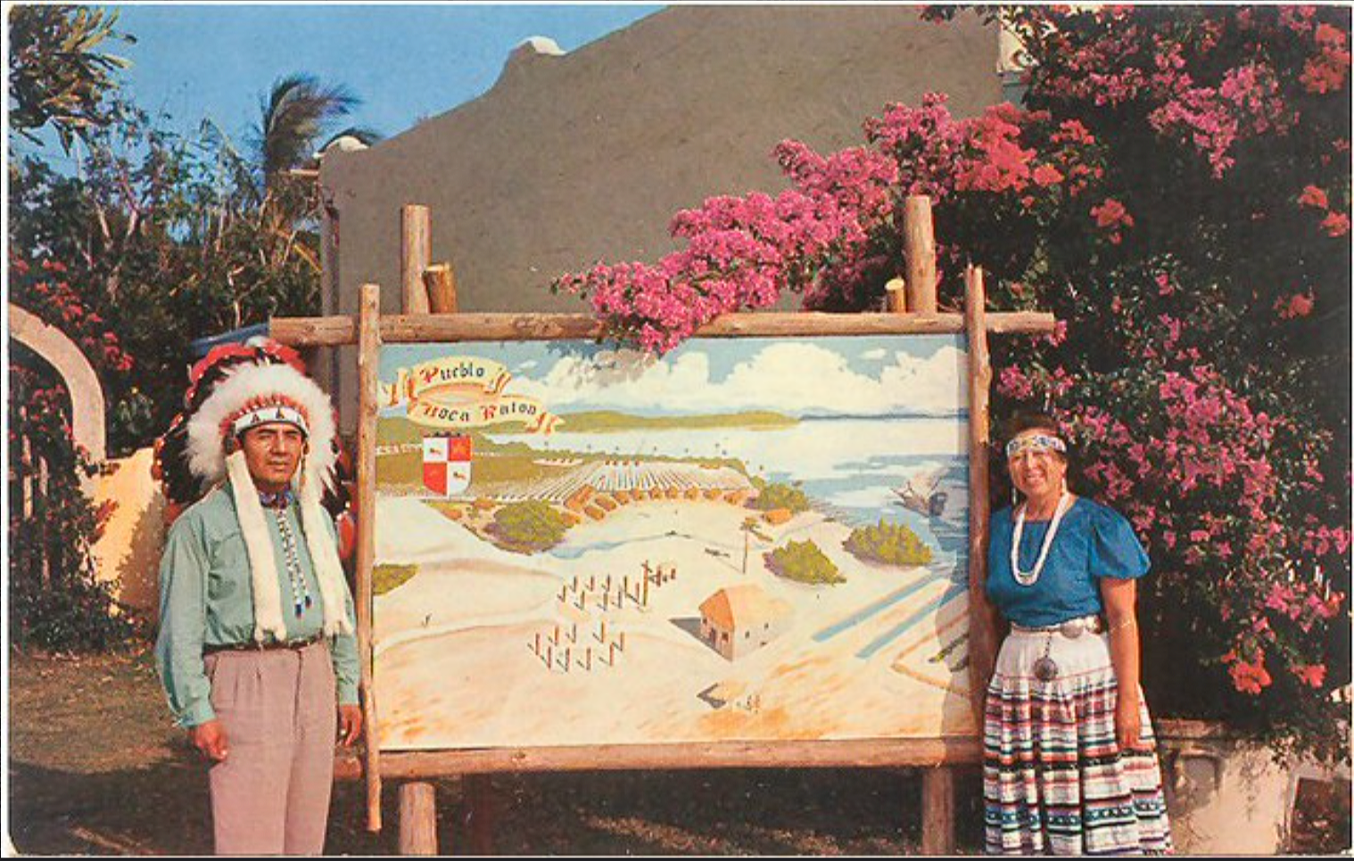 Vintage postcard of the Pueblo Boca Raton attraction sign with a man in a feathered headdress and a woman in a Seminole patchwork skirt